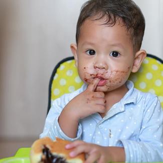 Baby Making a Mess with Chocolate